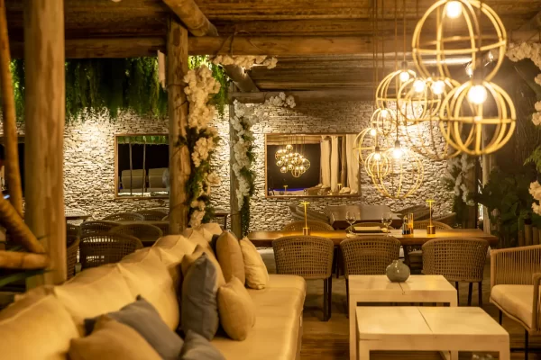 Preabeach lounge terrace with sofas, cushions and white floral arch