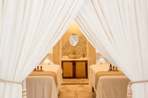 Couples massage room at Preabeach spa, two treatment tables under white curtains