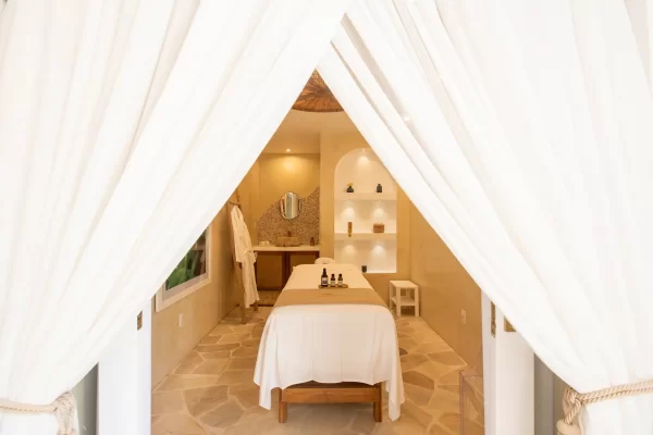 Single massage room at Preabeach spa, white curtains and stone washbasin