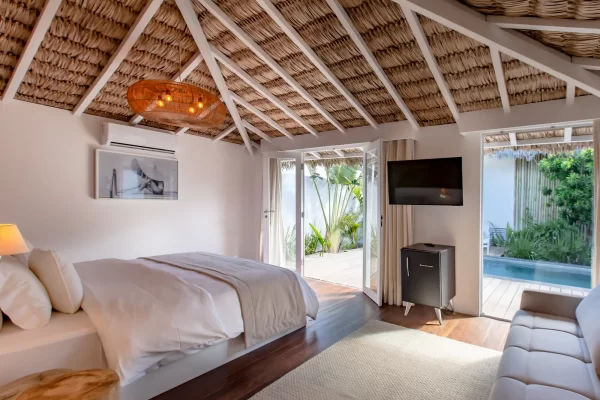 Preabeach bedroom opening onto the terrace and private pool, double bed and thatched roof