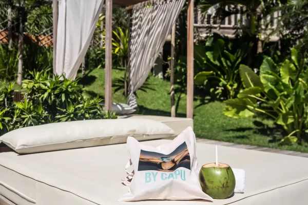 Daybed in Yemanja's garden with tote bag and coconut, tropical atmosphere